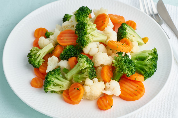 Mix of boiled vegetables. broccoli, carrots, cauliflower. steamed vegetables for diet Premium Photo